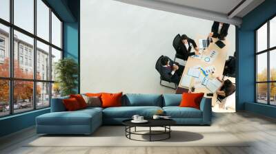 Top view on a group of businessman and businesswoman having a meeting and making a business commitment. Wall mural