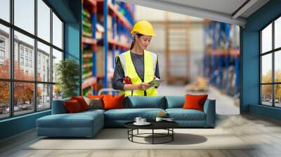 Warehouse workers checking the inventory. Products on inventory shelves storage. .Worker Doing Inventory in Warehouse. Dispatcher in uniform making inventory in storehouse. Wall mural