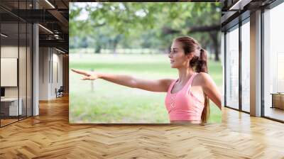 Young woman practicing yoga in the park.female happiness. Wall mural