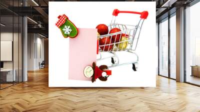 Blank greeting card with wooden decorative clothespins and Christmas tree toys in supermarket grocery shopping cart isolated on white background. Christmas, New Year, St. Nicholas Day. Winter holiday. Wall mural