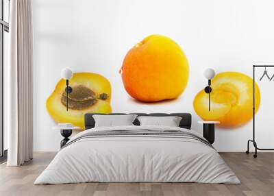 Ripe fresh organic apricot and two halves of apricot in dew drops isolated on a white background Wall mural