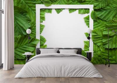 Beautiful, fresh green leaves with white square frame. Bright color. Empty place for inspirational text, quote or sayings. Flat lay. Top view. Wall mural