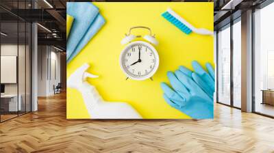 Cleaning set for different surfaces in kitchen, bathroom and other rooms. Bright yellow table background. Time for spring cleanup. Top down view. Closeup. Wall mural