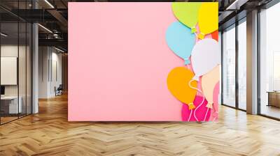 Colorful balloon shapes from application paper with white strings on light pink table background. Pastel color. Closeup. Empty place for inspirational text, quote or sayings. Top down view. Wall mural