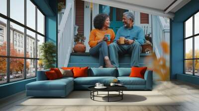 A couple enjoys coffee on the front porch steps of their home during a sunny afternoon in a friendly neighborhood Wall mural