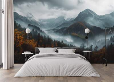 A misty mountain landscape at dawn with colorful autumn trees and majestic peaks shrouded in clouds Wall mural