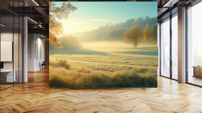 A peaceful sunrise over a misty meadow surrounded by autumn trees in a tranquil countryside setting Wall mural