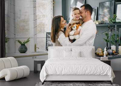 A portrait of happy family in the kitchen decorated for Christmas Wall mural