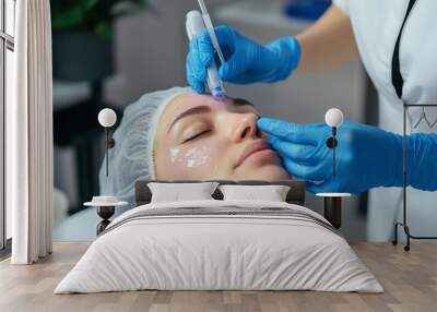 A skincare treatment session featuring a professional applying a microneedling technique in a serene clinic environment Wall mural