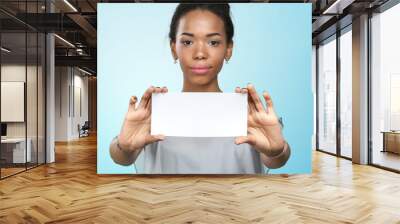 African american woman holding blank paper Wall mural