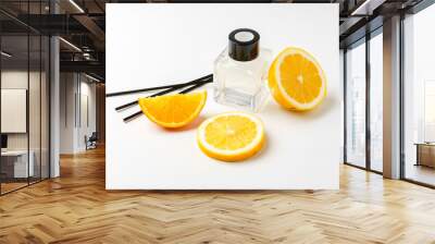 Aromatic display of essential oils with citrus fruit and chopsticks on a minimalist background Wall mural