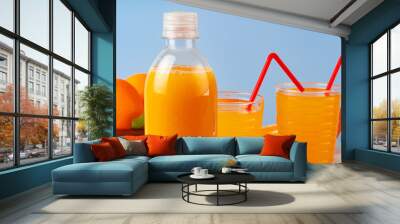 Bottle of orange juice and fresh oranges on table Wall mural