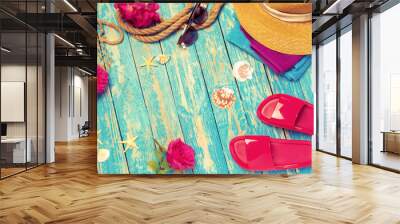 Bright composition of female  beach accessories on blue wooden background Wall mural