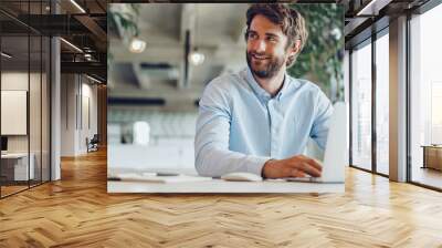 Businessman in shirt working on his laptop in an office. Open space office Wall mural