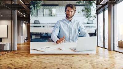 Businessman in shirt working on his laptop in an office. Open space office Wall mural