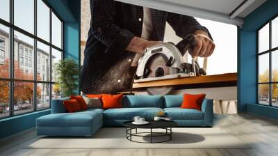 Carpenter hands cutting wood with electrical saw Wall mural