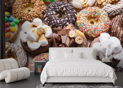 Close up of a selection of colorful donuts. Wall mural