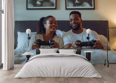 Couple enjoys an evening of gaming together on a cozy bed, sharing smiles and laughter in a serene bedroom setting Wall mural