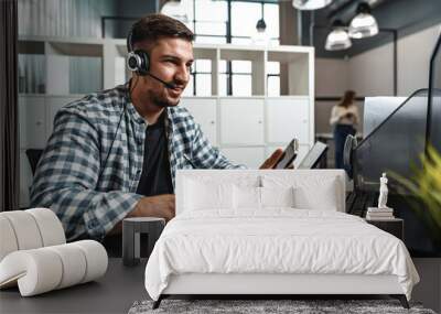 Customer service support operator man with headphones and microphone talking to client in call center Wall mural