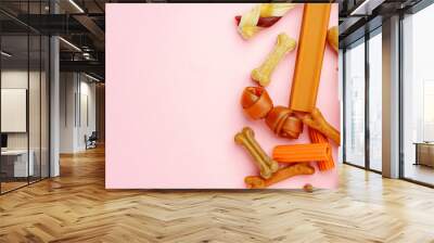 Dog chew bone and sticks on pink background Wall mural