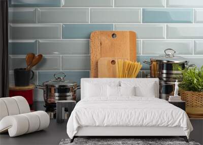 Dry spaghetti on a kitchen counter with cooking utensils close up Wall mural