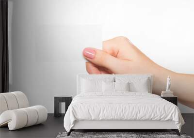 Empty sheet of paper in female hand with manicure isolated on white Wall mural