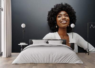 Fashionable young beautiful woman with hairstyle posing on the black wall Wall mural