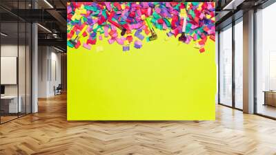 festive party decor and confetti on colored background Wall mural