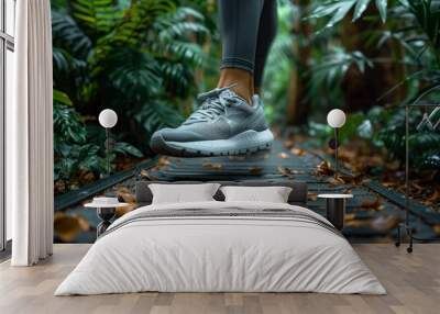 Grey Running Shoes Stepping on a Wooden Pathway in a Lush Tropical Forest Wall mural