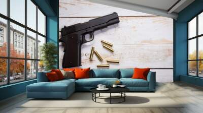 hand gun with rounds on wooden desk Wall mural