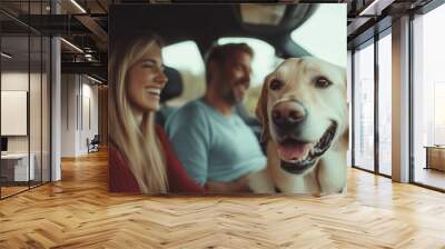 Happy couple enjoying a road trip with their cheerful golden retriever on a sunny day in the countryside Wall mural