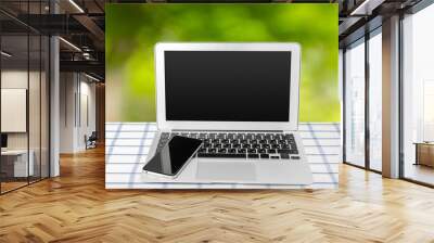 Laptop with blank screen on table Wall mural