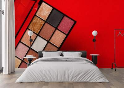 Makeup eyeshadow palette on the red background. Close up. Wall mural