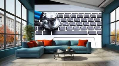 Medical stethoscope on computer keyboard Wall mural