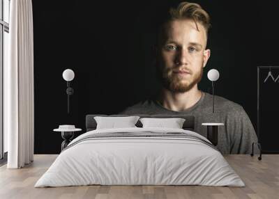 portrait of young man above black background Wall mural