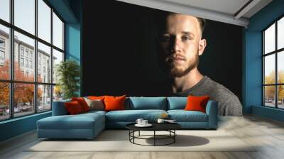 portrait of young man above black background Wall mural