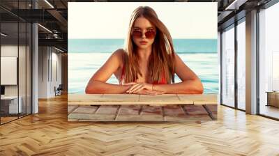 Pretty woman portrait in a swimming pool on vacations Wall mural