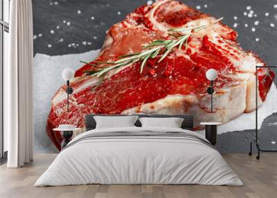 Raw fresh meat t-bone steak with spices on a dark background, close up Wall mural