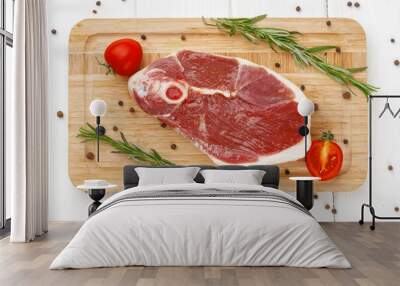 Raw lamb steak on board on white wooden table Wall mural