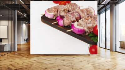 Raw marinated kebab on skewers on wooden background Wall mural