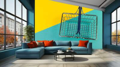 shopping basket on a colored background Wall mural