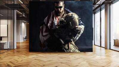 Soldier holding machine gun with national flag Wall mural