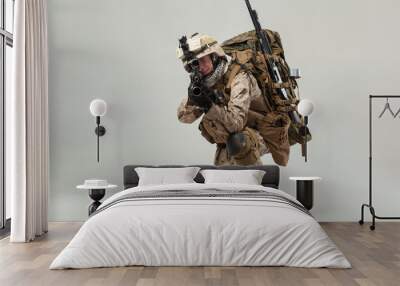 Soldier in camouflage holding rifle Wall mural