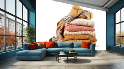 Stack of various sweaters isolated on white background Wall mural