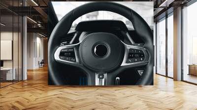 Steering wheel of a new luxury car Wall mural