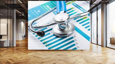 stethoscope with financial on the desk. Wall mural