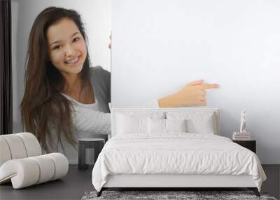 Woman smiling showing white blank sign billboard Wall mural