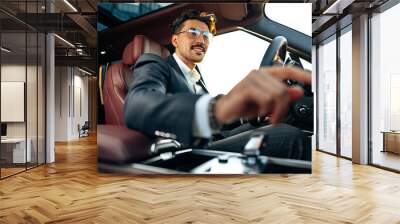 Young businessman in elegant suit driving luxury car Wall mural