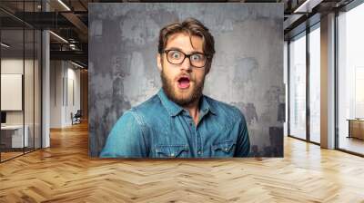 young handsome man with surprised face expression Wall mural