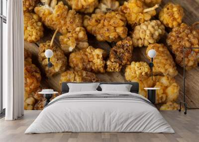 Dried mulberry fruit on a wooden chopping board. Artificial, soft light from two flash units Wall mural